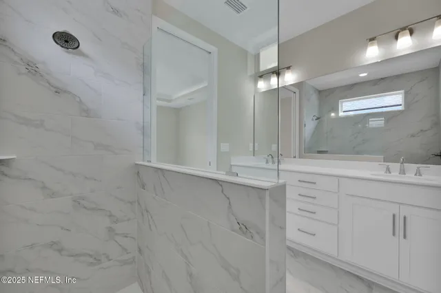 a bathroom with a sink and mirror