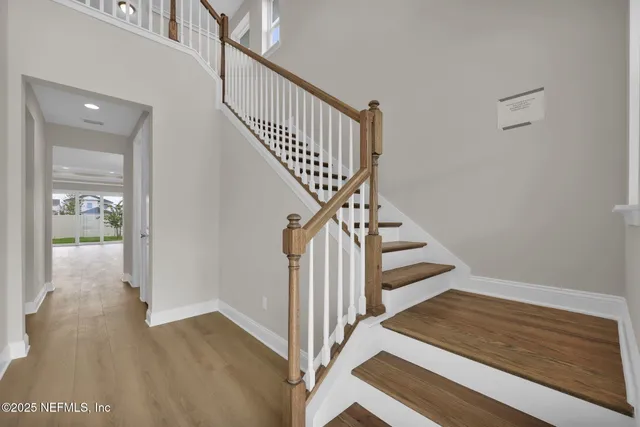 a view of entryway and hall with wooden floor