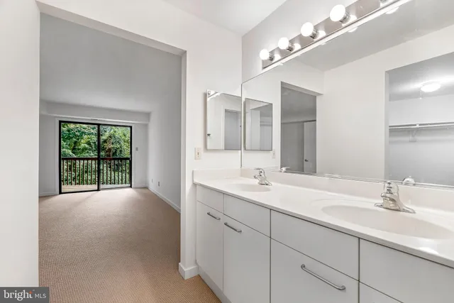 a bathroom with a double vanity sink and a mirror