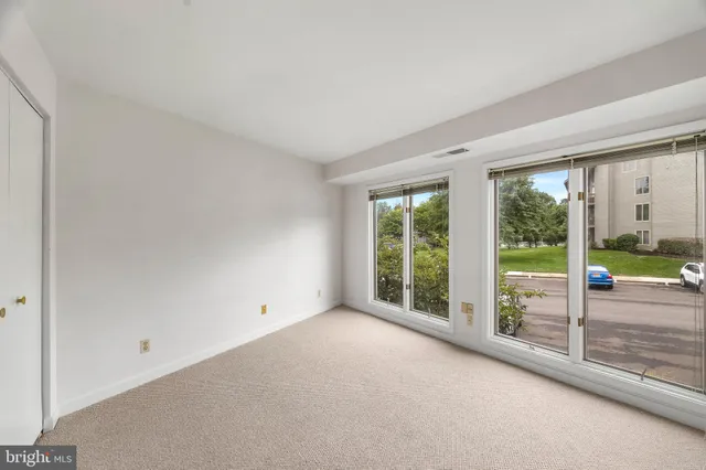 an empty room with large windows