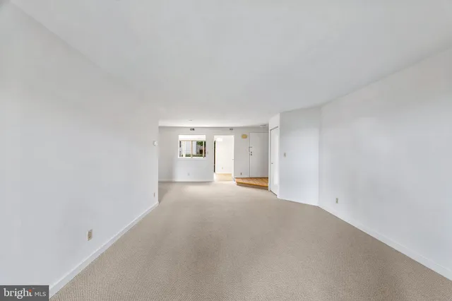a kitchen with a white stove a sink and a refrigerator