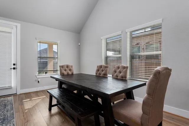 a view of a dining room with furniture and window