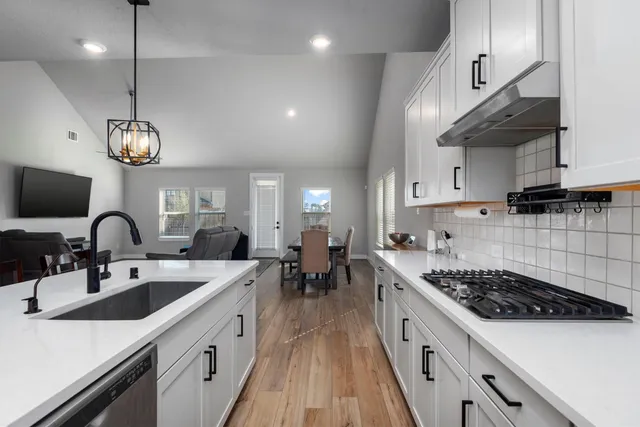 a kitchen with lots of counter space and sink