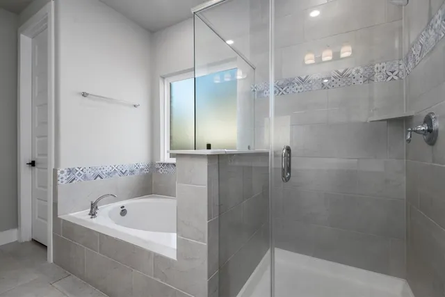 a bathroom with a bathtub and a shower