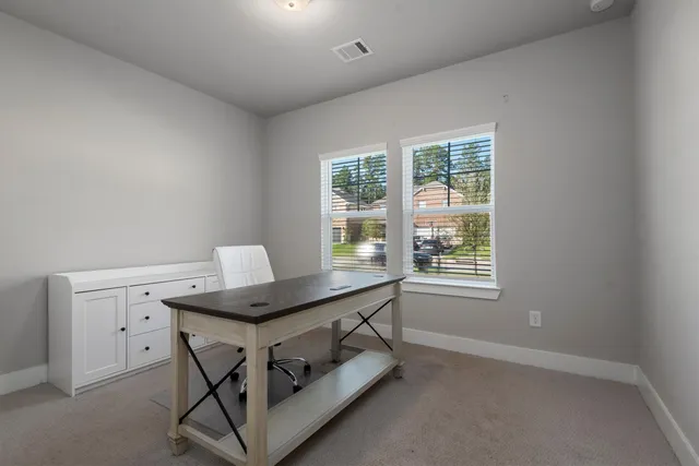 a room with a table and windows