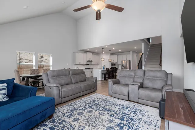 a living room with furniture and a chandelier