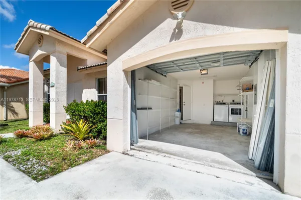a view of a big house with wooden floor and a garage