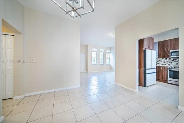 a view of a kitchen with furniture and an empty room