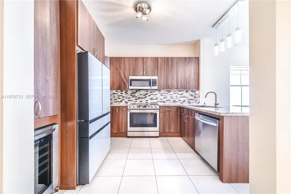 a kitchen with a stove top oven and cabinets