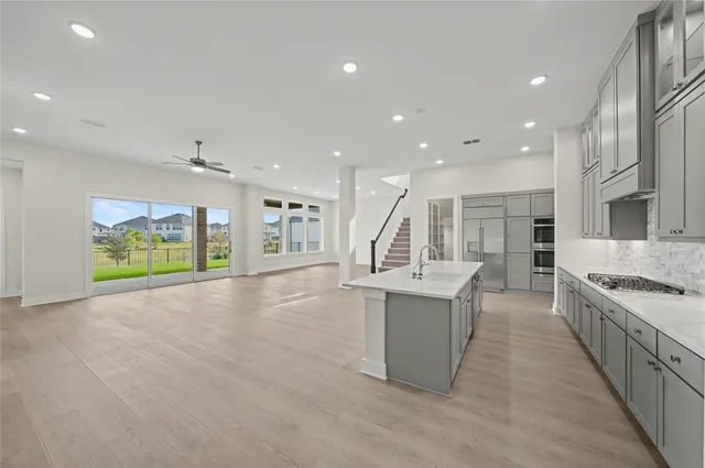 a kitchen with stainless steel appliances granite countertop a stove and a sink