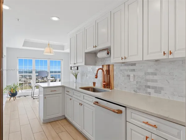 a kitchen with kitchen island white cabinets and white appliances