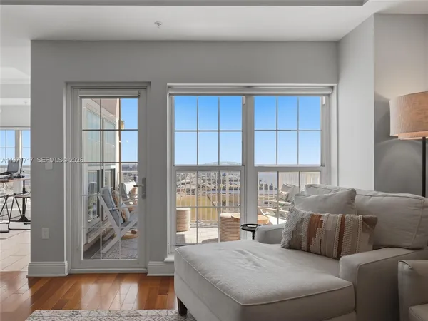 a living room with furniture and a wooden floor
