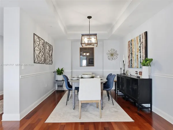 a view of a dining room with furniture and a window