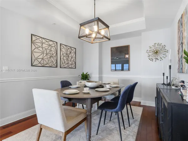 a kitchen with stainless steel appliances granite countertop a refrigerator a sink a stove and a refrigerator with wooden floor