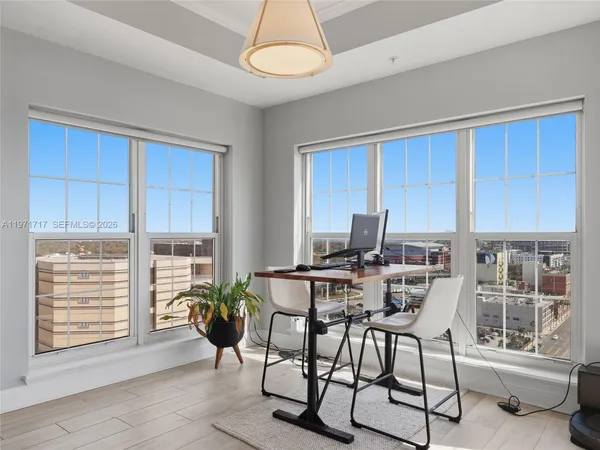 a balcony with furniture and a large window