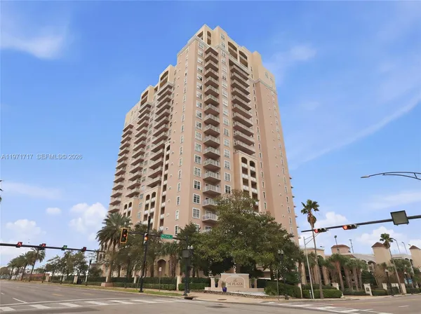 a view of a tall building next to a road