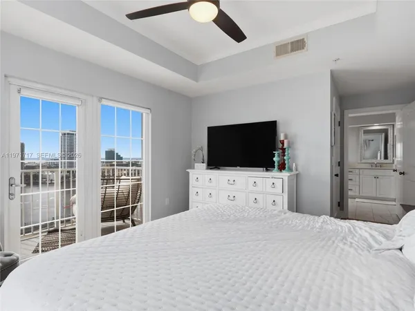 a bedroom with a large bed and a large window