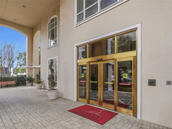 a very nice looking room with many windows and furniture