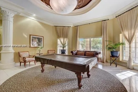 a patio with a table and chairs and potted plants