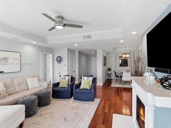a living room with furniture a fireplace and a flat screen tv