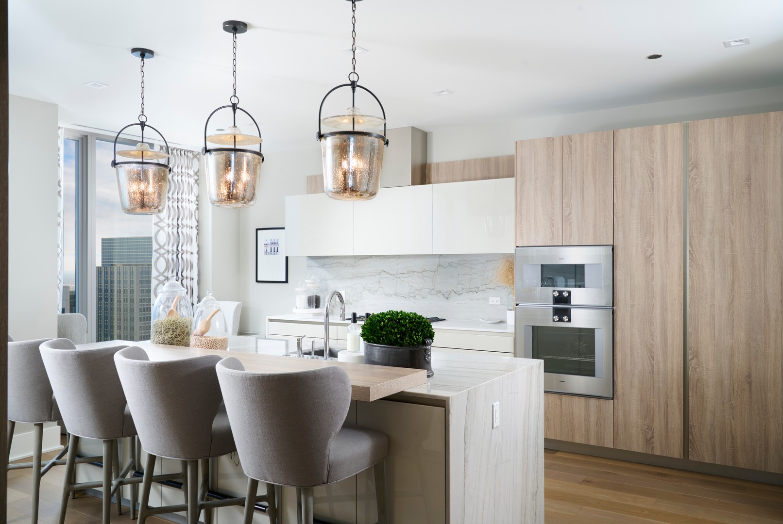 363 East Wacker Drive, Unit 6106 Chicago, IL 60601 - Photo 15 of 48 a kitchen with a table chairs and white cabinets