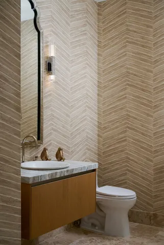 a bathroom with a toilet a sink a mirror and shower curtain