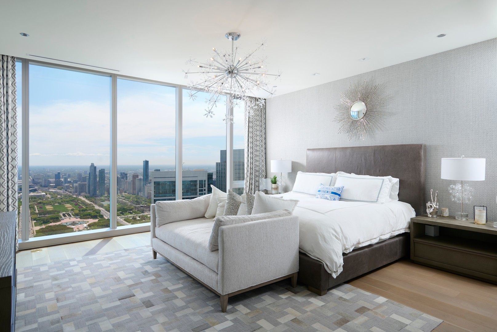 363 East Wacker Drive, Unit 6106 Chicago, IL 60601 - Photo 20 of 48 a bedroom with a large bed and a chandelier