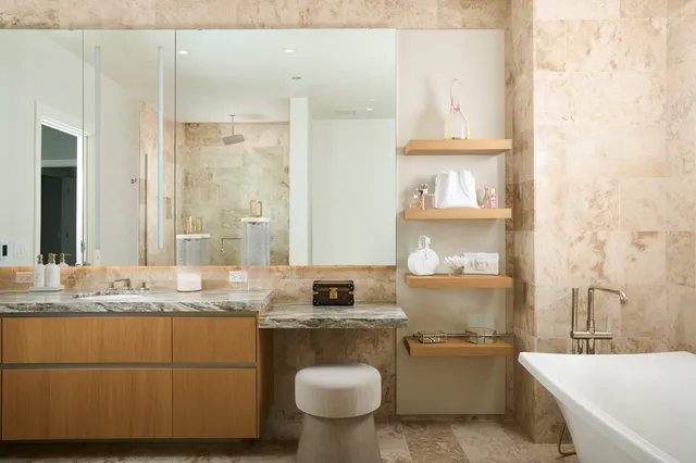 a bathroom with a granite countertop sink mirror vanity and toilet