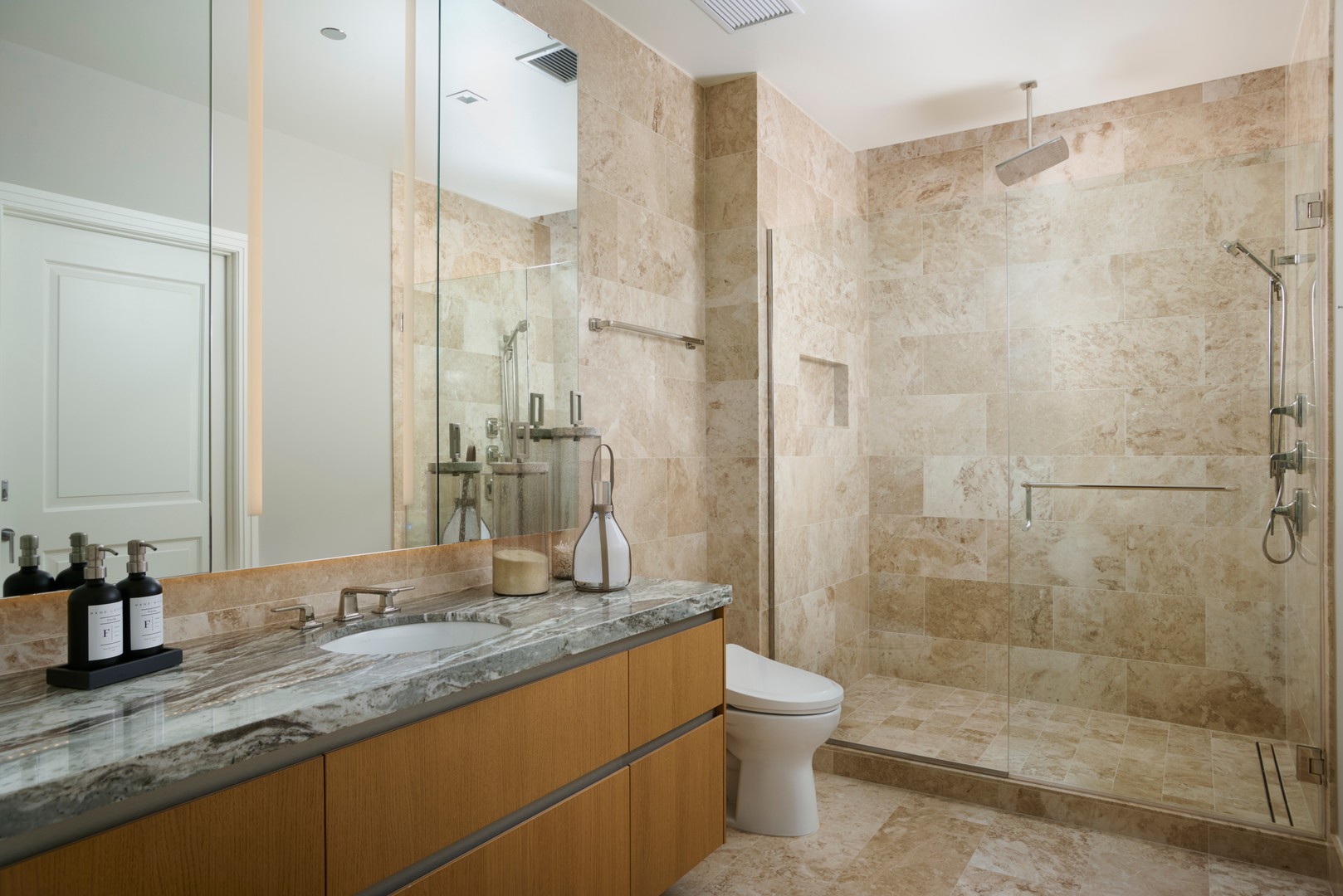 363 East Wacker Drive, Unit 6106 Chicago, IL 60601 - Photo 24 of 48 a bathroom with a granite countertop sink a toilet and shower