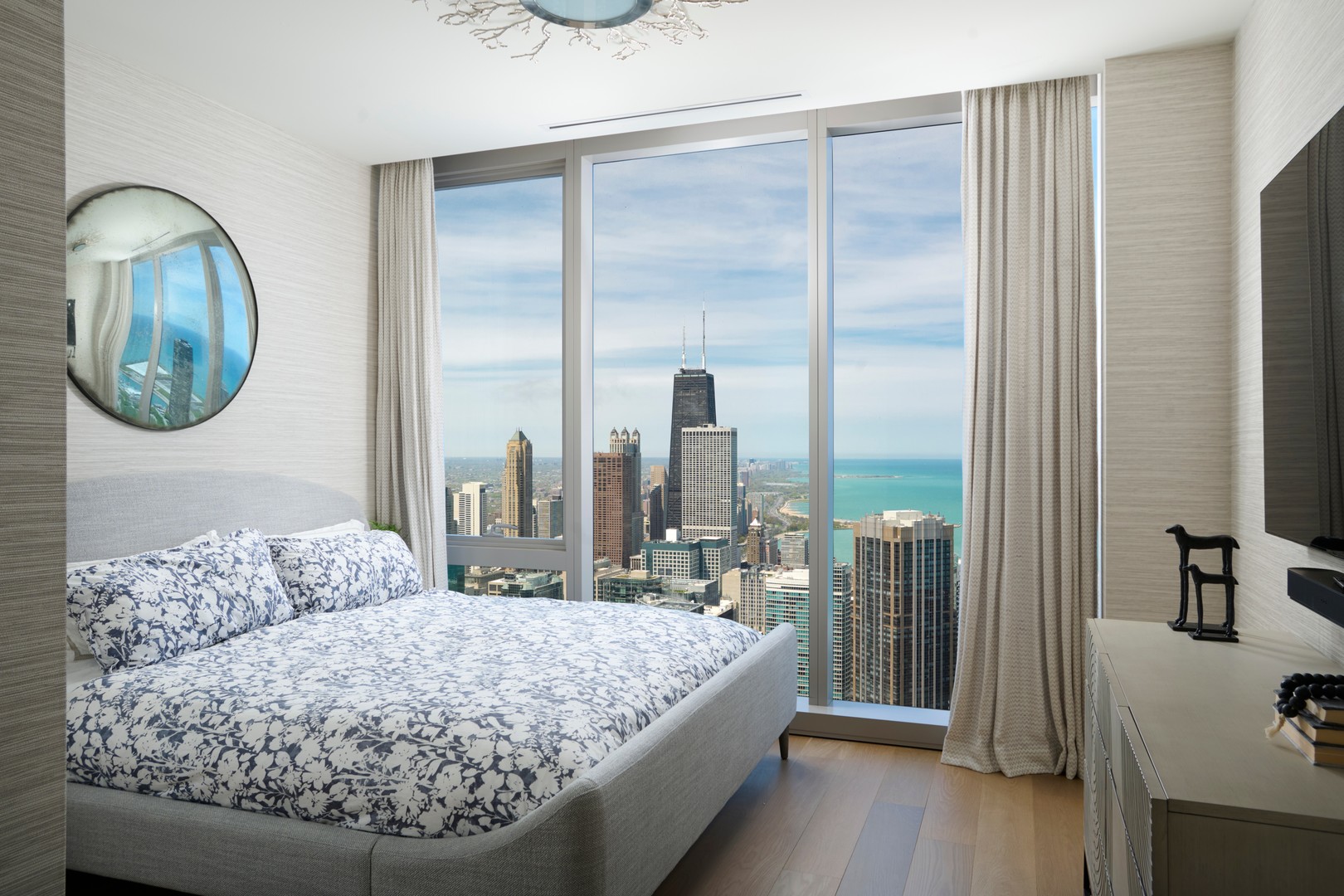 363 East Wacker Drive, Unit 6106 Chicago, IL 60601 - Photo 25 of 48 a bedroom with a large bed and a chandelier