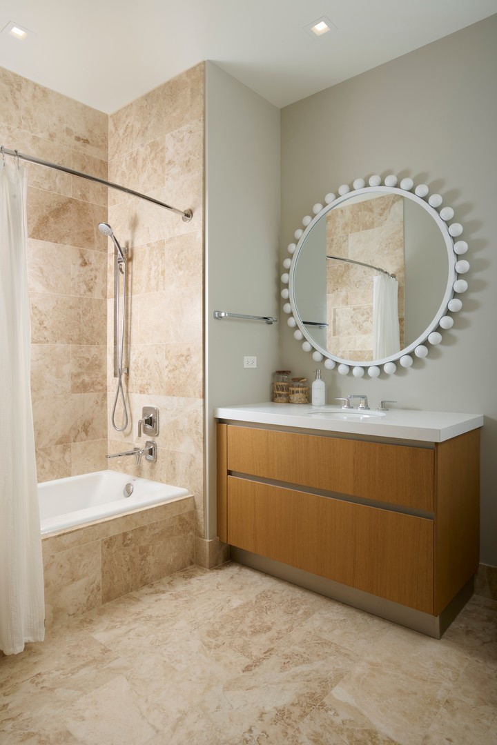 363 East Wacker Drive, Unit 6106 Chicago, IL 60601 - Photo 26 of 48 a bathroom with a tub sink and mirror
