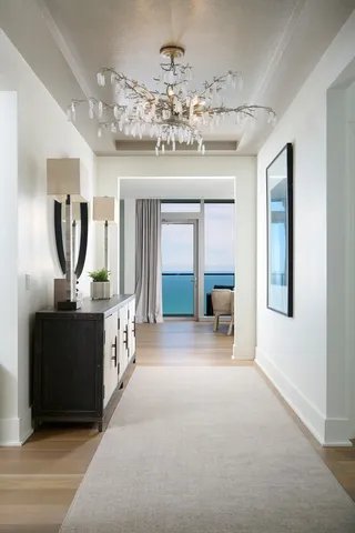 a view of a hallway with chandelier