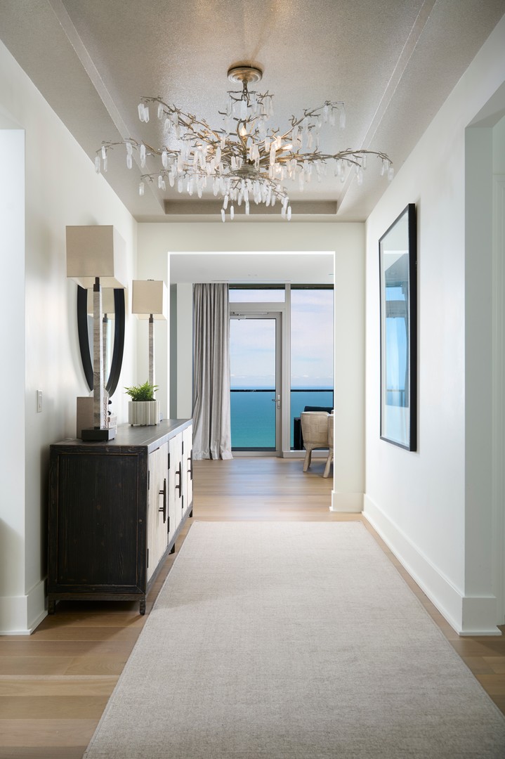 363 East Wacker Drive, Unit 6106 Chicago, IL 60601 - Photo 3 of 48 a view of a hallway with chandelier