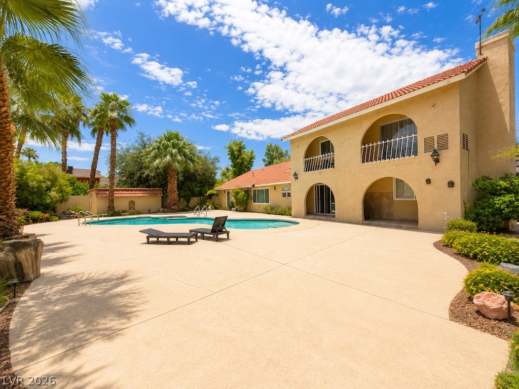 3010 East Viking Road Las Vegas, NV 89121 - Photo 46 of 48 A spacious poolside patio and lush garden landscaping offer a tranquil outdoor oasis.