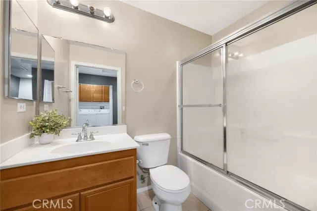 a bedroom with bed and a large window