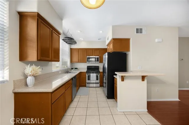 a kitchen with stainless steel appliances granite countertop a sink counter space and cabinets