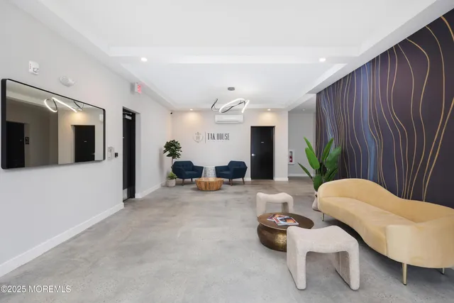 a living room with furniture kitchen and a table