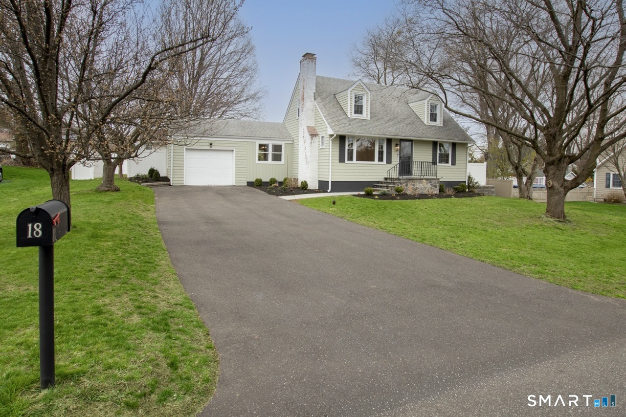 18 Maple Street Trumbull, CT 06611 - Photo 1 of 1 a front view of a house with a yard and garage