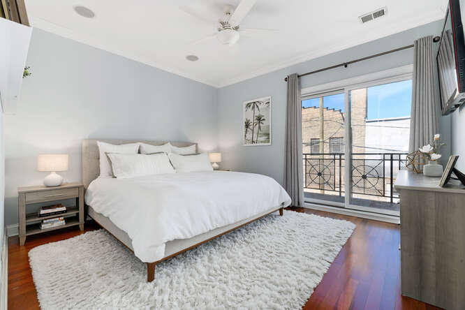 2118 West Rice Street, Unit 2 Chicago, IL 60622 - Photo 13 of 22 a bedroom with a large bed and a large window