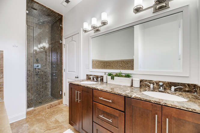 2118 West Rice Street, Unit 2 Chicago, IL 60622 - Photo 15 of 22 a bathroom with a granite countertop sink a mirror and a shower