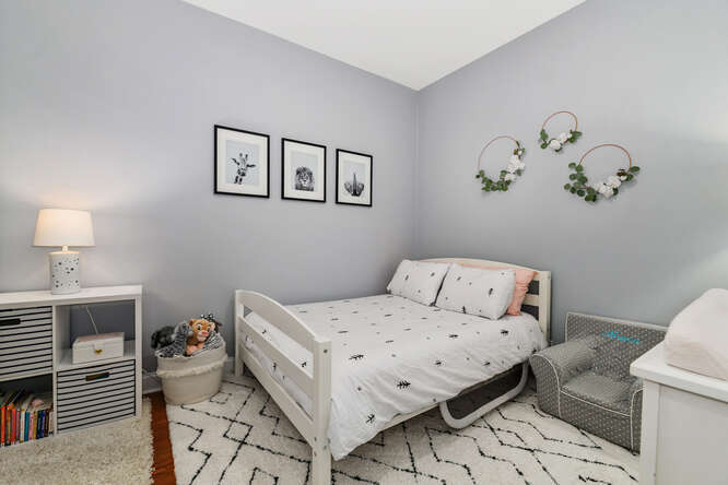 2118 West Rice Street, Unit 2 Chicago, IL 60622 - Photo 17 of 22 a bedroom with a bed and wooden floor