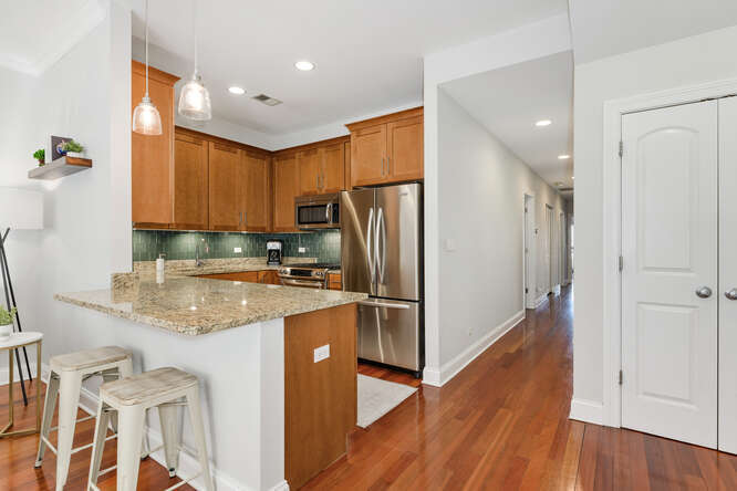 2118 West Rice Street, Unit 2 Chicago, IL 60622 - Photo 5 of 22 a kitchen with a refrigerator sink and cabinets