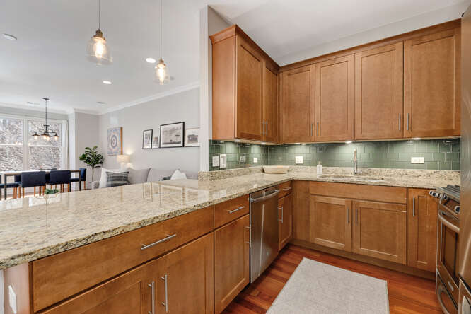 2118 West Rice Street, Unit 2 Chicago, IL 60622 - Photo 8 of 22 a kitchen with granite countertop a sink a stove cabinets and wooden floor