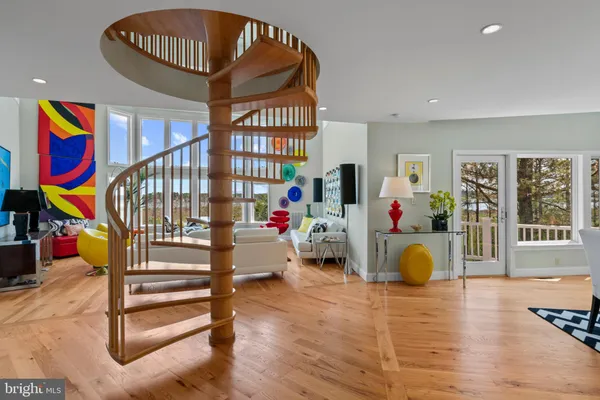 a kitchen with stainless steel appliances granite countertop a sink a stove and a wooden floors