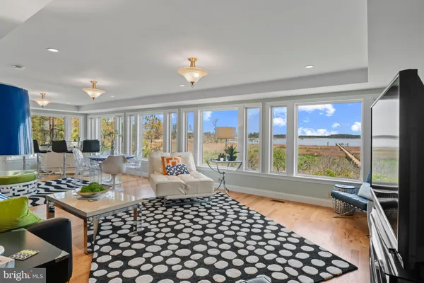 a living room with furniture and floor to ceiling windows