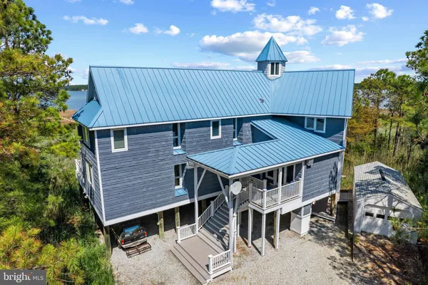 an aerial view of a house with a lake view