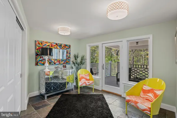 a living room with patio furniture and a wooden floor