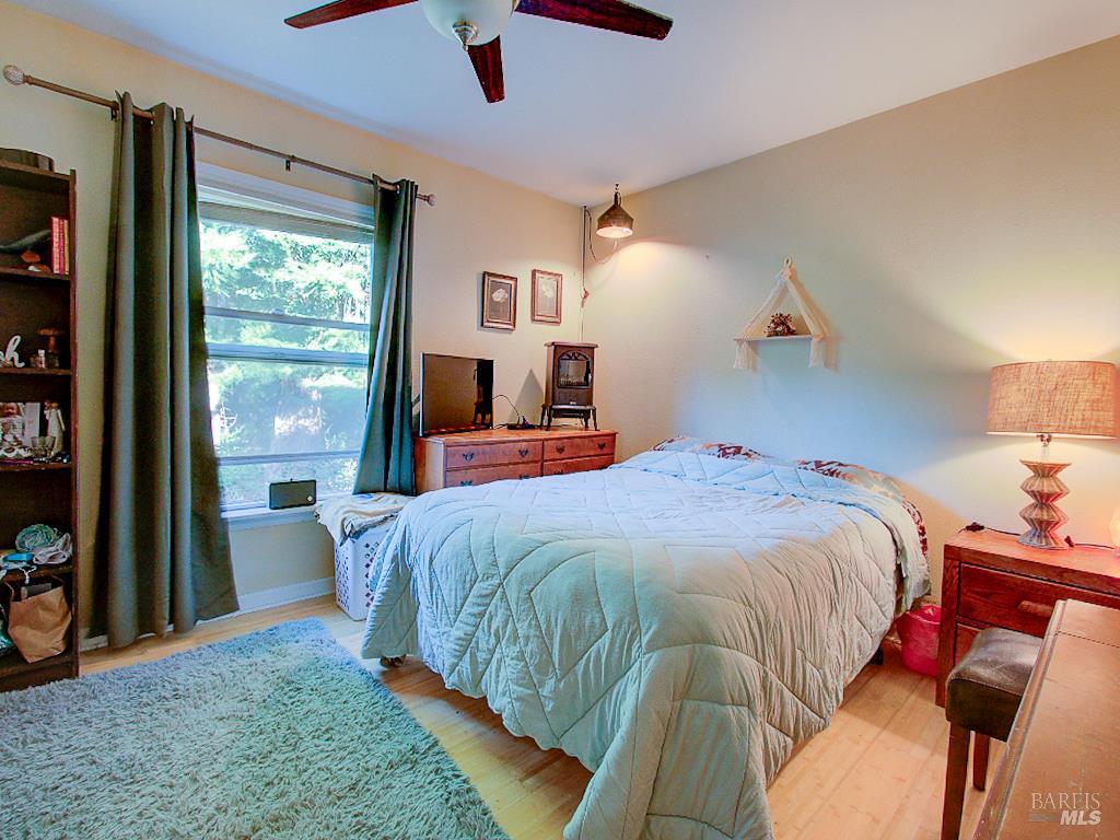 31191 Turner Road Fort Bragg, CA 95437 - Photo 22 of 36 a bedroom with a large bed and a tv