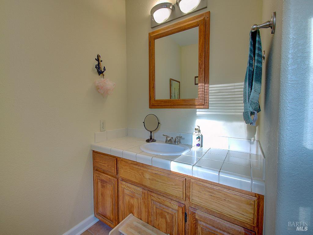 31191 Turner Road Fort Bragg, CA 95437 - Photo 28 of 36 a bathroom with a sink a vanity and mirror