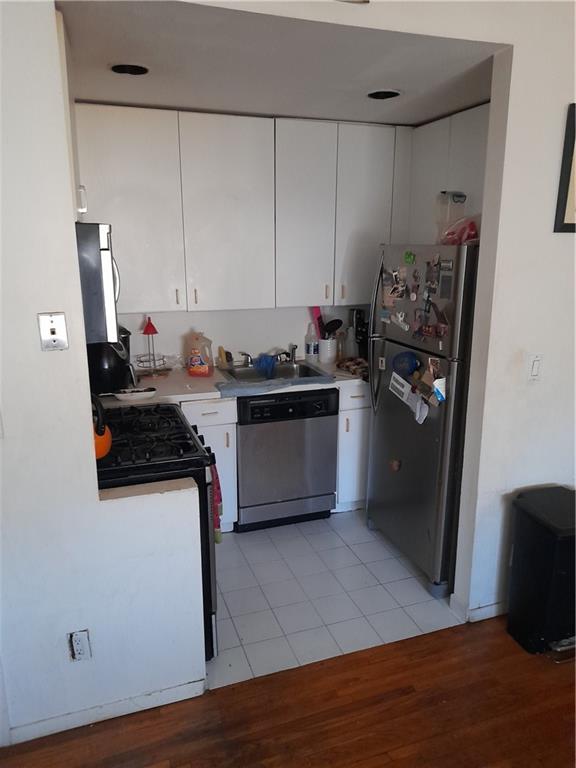 4050 Nostrand Avenue, Unit 1F Brooklyn, NY 11235 - Photo 5 of 9 a kitchen with a sink stove and refrigerator